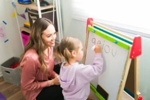 A group of toddlers engaging in sensory play at a licensed childcare development center, focusing on fine motor skills and cognitive curiosity.