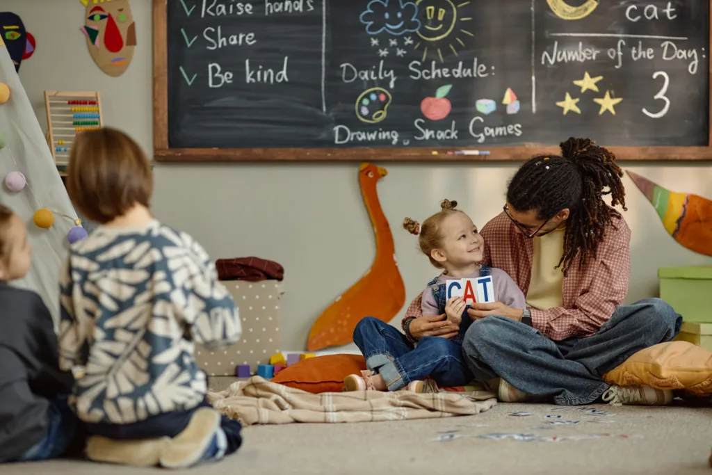 A group of happy toddlers participating in an interactive storytelling circle during a structured afternoon lesson within premium early education programs, demonstrating high-quality language development and peer socialization.