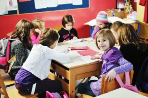A bright and modern classroom interior of one of the many preschools in langley, featuring child-sized wooden furniture, colorful learning stations, and a safe, inviting atmosphere for early childhood education.