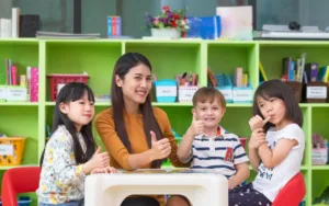 A bright and engaging classroom at KiddieKollege, a premier daycare in Langley, where happy preschoolers are participating in a play-based early learning activity.