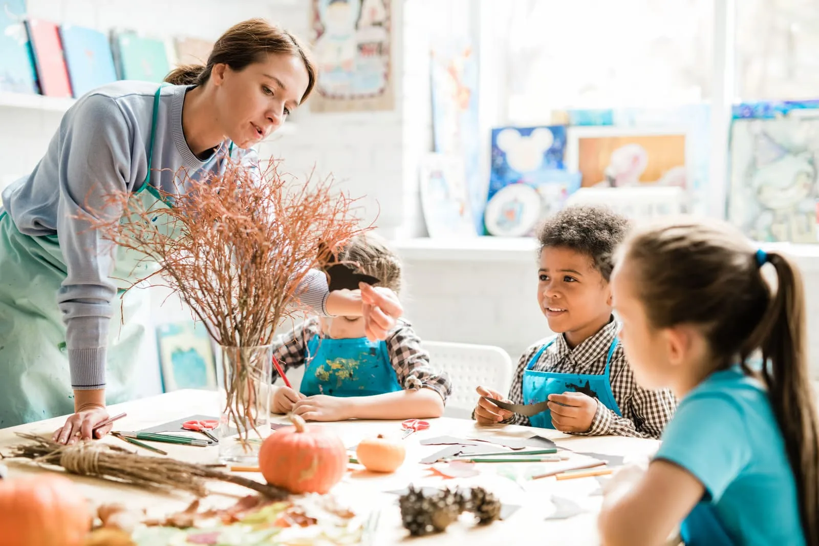 A bright, organized classroom environment inside a licensed daycare in Langley, featuring young children collaborating on an early literacy activity with educational blocks.