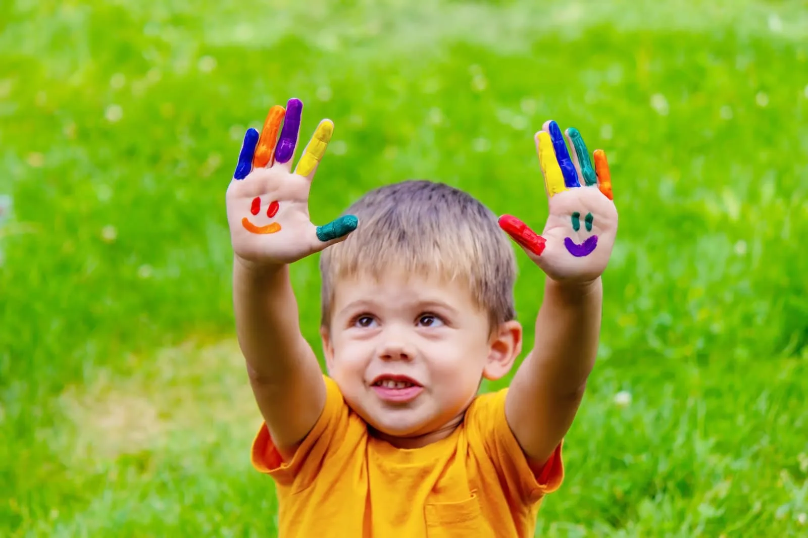 A group of happy toddlers sitting in a sunlit circle during a positive guidance activity at the Kiddie Club Childcare Center, demonstrating social-emotional development.